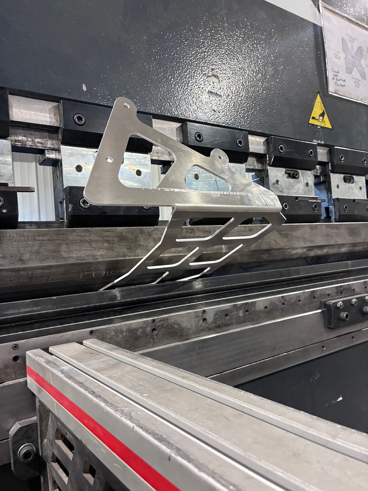 Press brake forming a laser-cut part